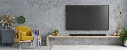 tv-room-interior-with-yellow-armchair-loft-style-house-concrete-wall-background